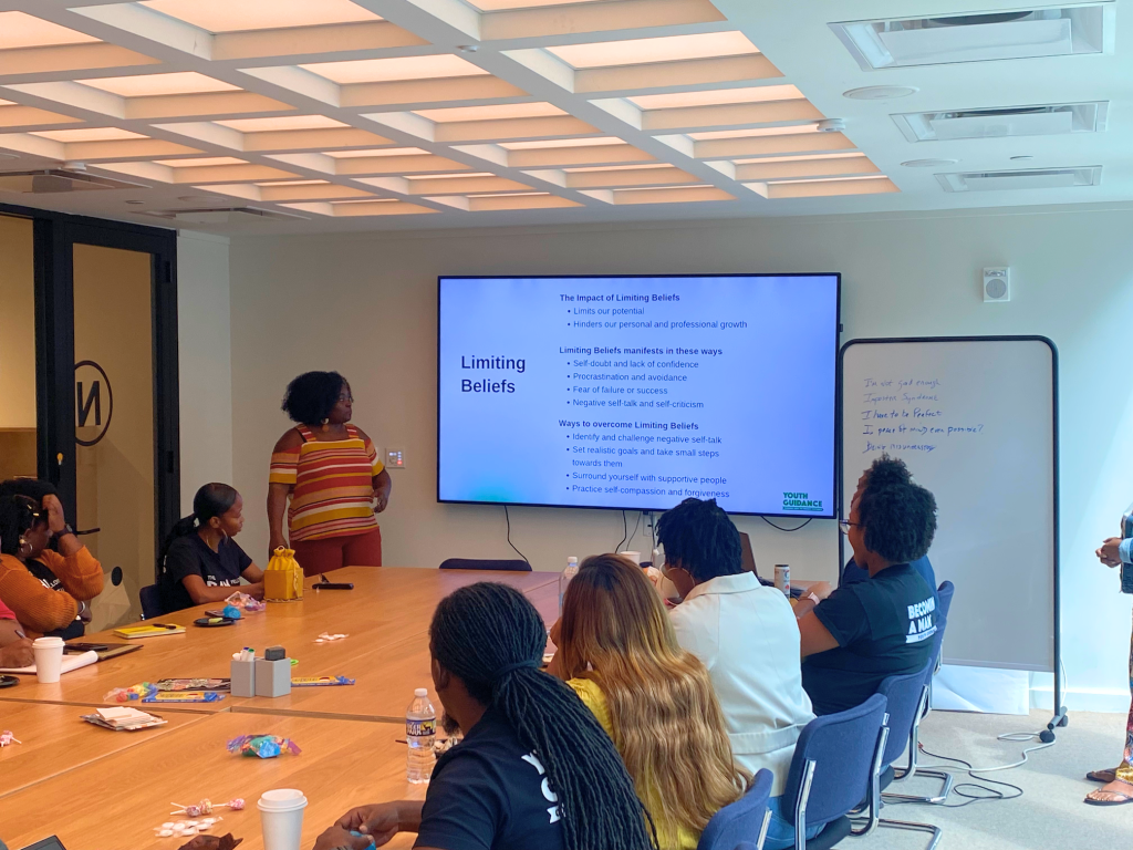 Woman standing in classroom giving training to employees
